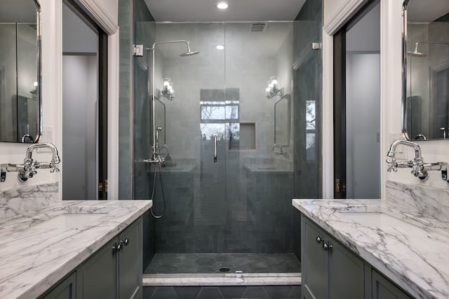 bathroom featuring vanity and an enclosed shower