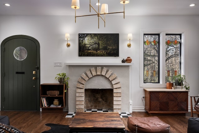 living room featuring a brick fireplace and dark hardwood / wood-style floors