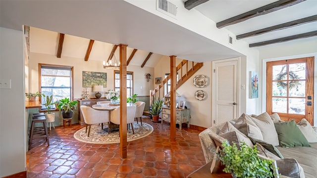 interior space featuring a chandelier and vaulted ceiling with beams