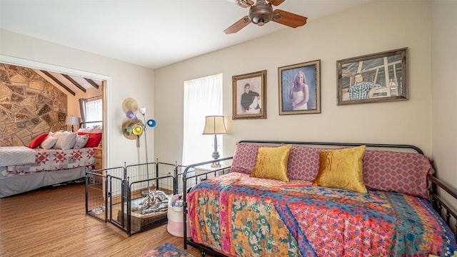 bedroom featuring hardwood / wood-style floors and lofted ceiling with beams