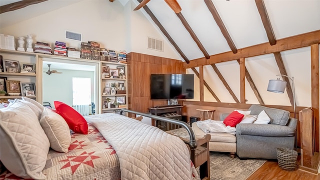 bedroom with wood-type flooring, beam ceiling, and high vaulted ceiling