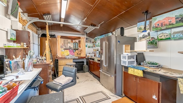 kitchen with high end fridge and vaulted ceiling