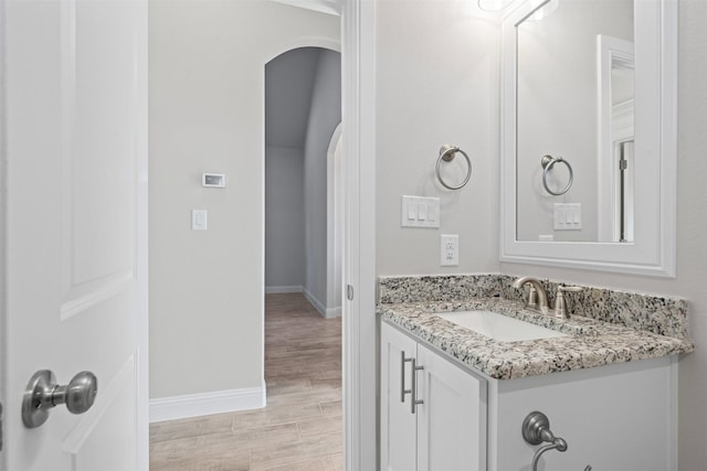 729 Jameson, Springtown, TX 76082 - bathroom featuring vanity, baseboards, and wood finished floors