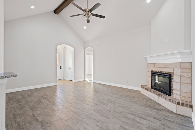 729 Jameson, Springtown, TX 76082 - unfurnished living room with a ceiling fan, beam ceiling, high vaulted ceiling, arched walkways, and recessed lighting