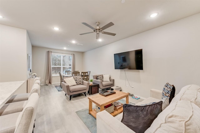 living room featuring ceiling fan and light wood-type flooring