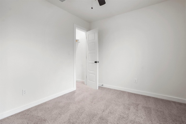 spare room featuring carpet floors and ceiling fan