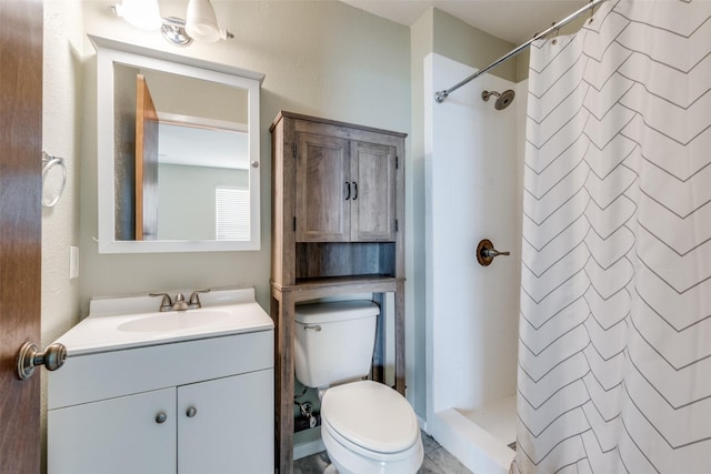 full bath featuring vanity, a shower stall, and toilet