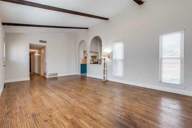 unfurnished living room with visible vents, baseboards, and wood finished floors