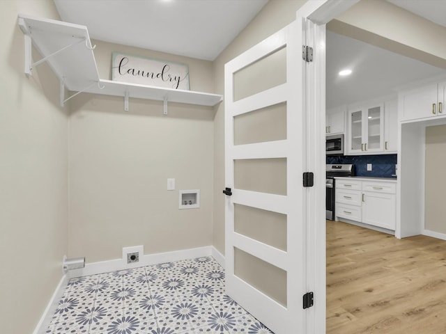 laundry room featuring hookup for a washing machine, hookup for an electric dryer, and light wood-type flooring