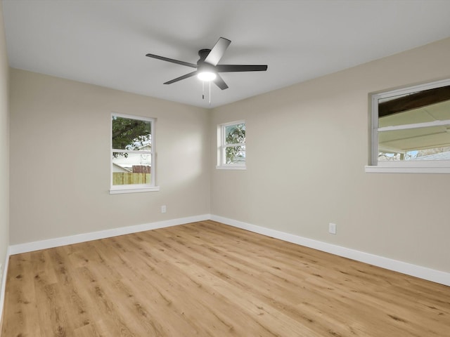 empty room with ceiling fan and light hardwood / wood-style floors