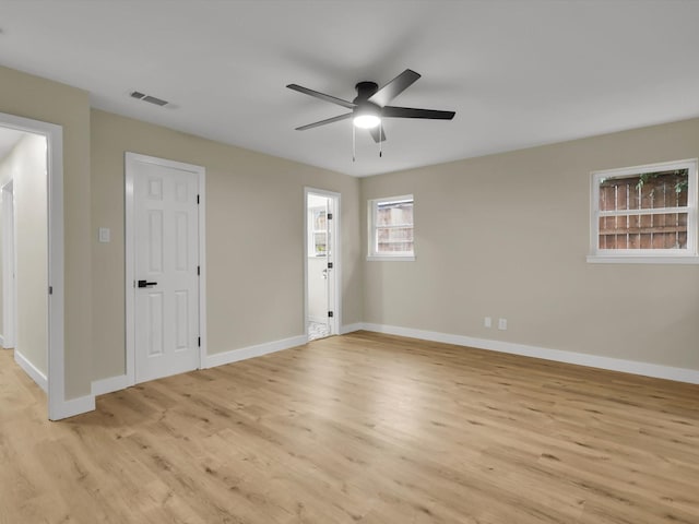 empty room featuring ceiling fan and light hardwood / wood-style floors