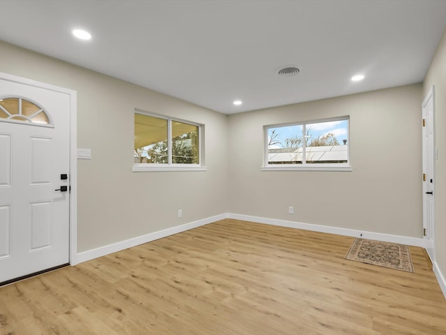 entrance foyer with a wealth of natural light and light hardwood / wood-style floors