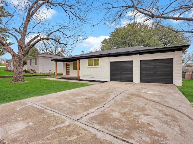 single story home featuring a garage and a front lawn