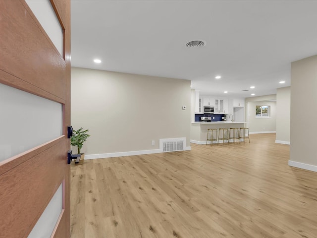 6005 Saint Johns Ln, Fort Worth, TX 76114 - unfurnished living room with light wood finished floors, baseboards, visible vents, and recessed lighting