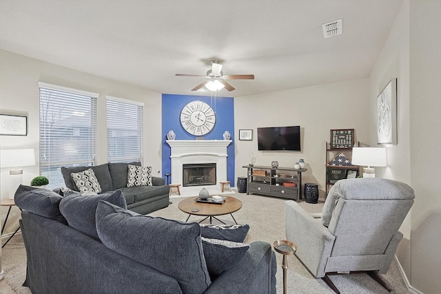 carpeted living room featuring ceiling fan