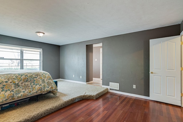 bedroom featuring dark wood-type flooring