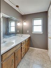 bathroom with vanity, plenty of natural light, and tile patterned floors