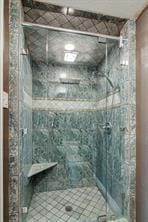 bathroom with a tile shower