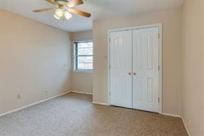 unfurnished bedroom featuring ceiling fan, carpet flooring, and a closet