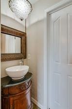 bathroom with vanity and a notable chandelier