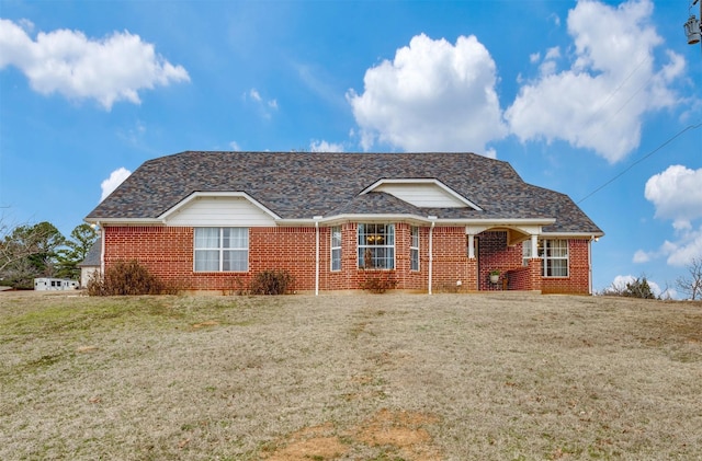 single story home featuring a front lawn and brick siding