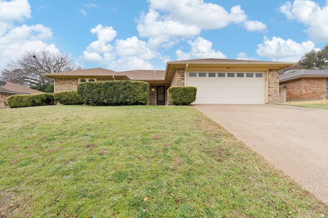 view of front facade with brick siding, an attached garage, concrete driveway, and a front yard