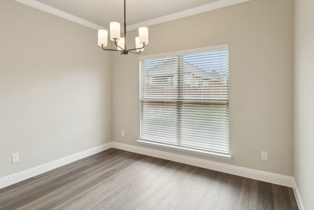 212 Navajo Trl, Alvarado, TX 76009 - empty room featuring baseboards, ornamental molding, dark wood-type flooring, and a notable chandelier