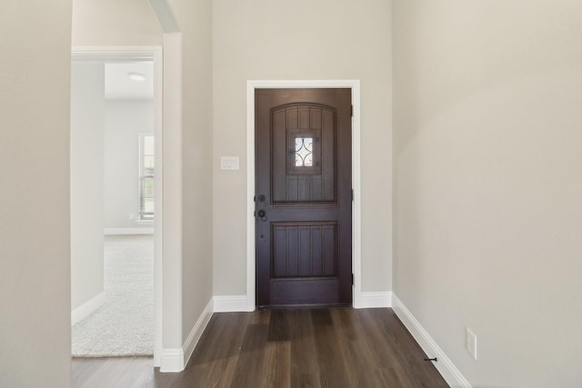 212 Navajo Trl, Alvarado, TX 76009 - entryway featuring arched walkways, baseboards, dark wood-style floors, and a healthy amount of sunlight