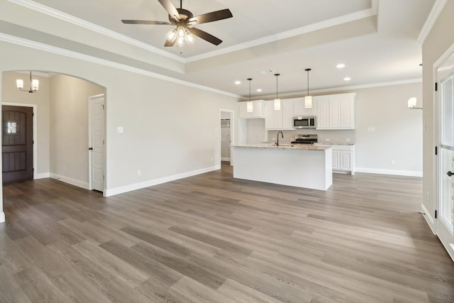 212 Navajo Trl, Alvarado, TX 76009 - unfurnished living room featuring a sink, baseboards, recessed lighting, and wood finished floors