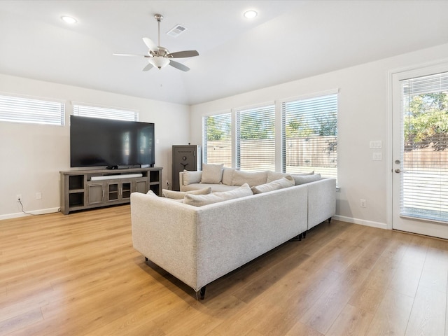 living room featuring light hardwood / wood-style flooring, ceiling fan, and vaulted ceiling