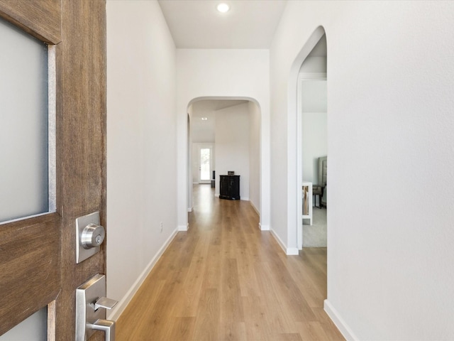 corridor with light hardwood / wood-style flooring