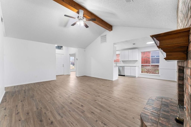 unfurnished living room with high vaulted ceiling, a textured ceiling, beamed ceiling, ceiling fan, and light hardwood / wood-style floors