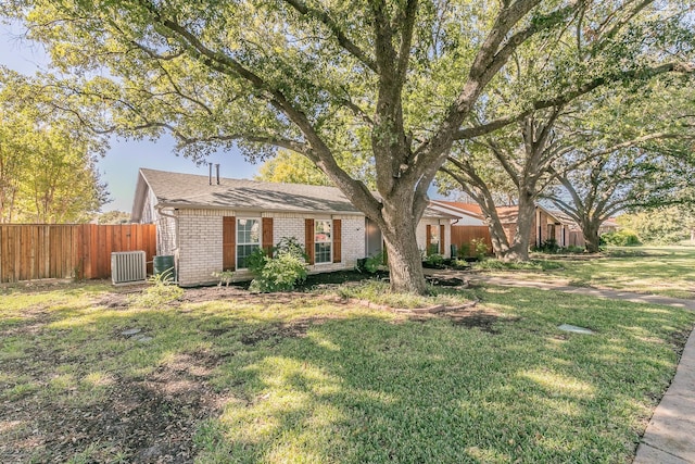 single story home with a front yard and cooling unit