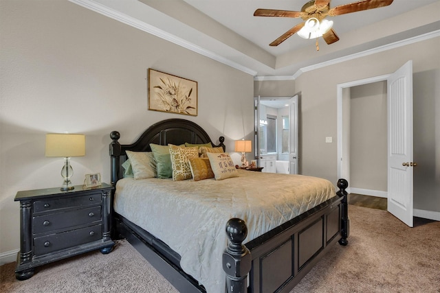 bedroom featuring crown molding, ensuite bath, ceiling fan, carpet flooring, and a raised ceiling