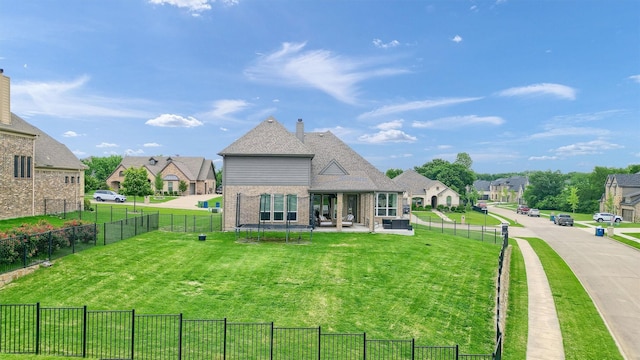 back of house featuring a yard and a trampoline