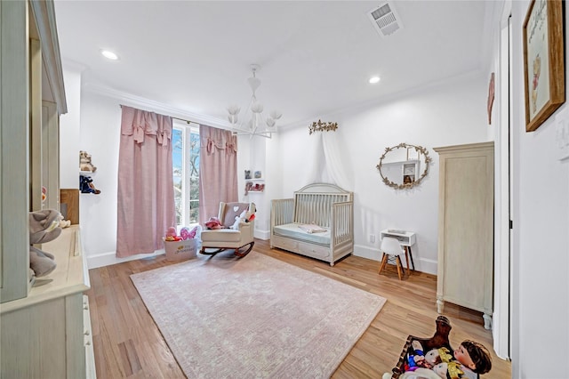 sitting room featuring an inviting chandelier and light hardwood / wood-style flooring