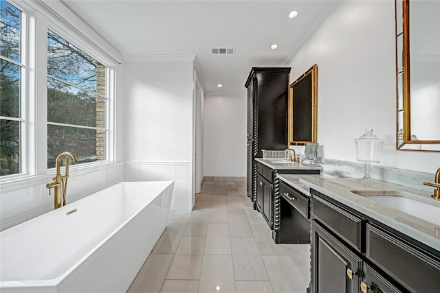 bathroom featuring vanity, a tub, and tile patterned floors