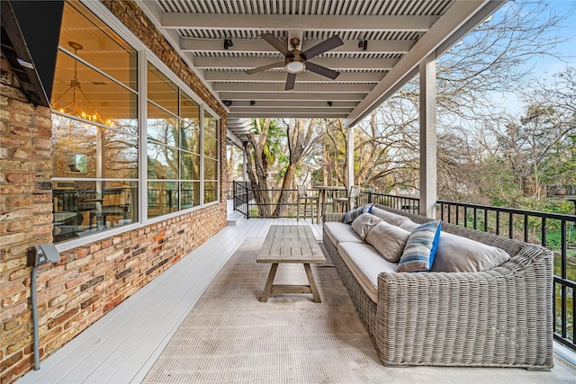 wooden deck with an outdoor hangout area and ceiling fan