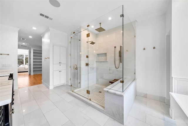 bathroom featuring tile patterned floors, crown molding, vanity, and an enclosed shower