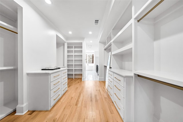 walk in closet featuring light hardwood / wood-style flooring