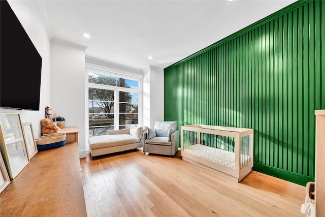 sitting room featuring crown molding and wood-type flooring