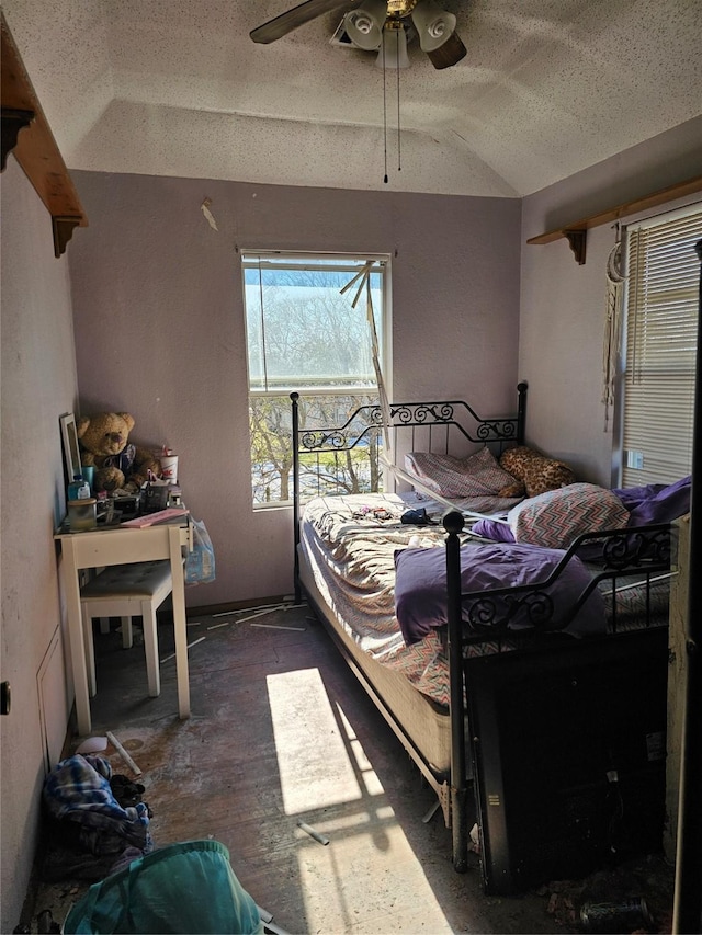 bedroom with ceiling fan, lofted ceiling, dark hardwood / wood-style floors, and a textured ceiling