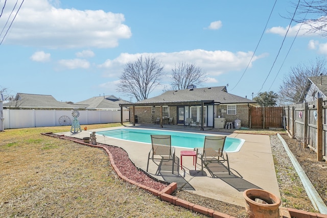 view of swimming pool featuring a yard, a fenced in pool, a fenced backyard, and a patio