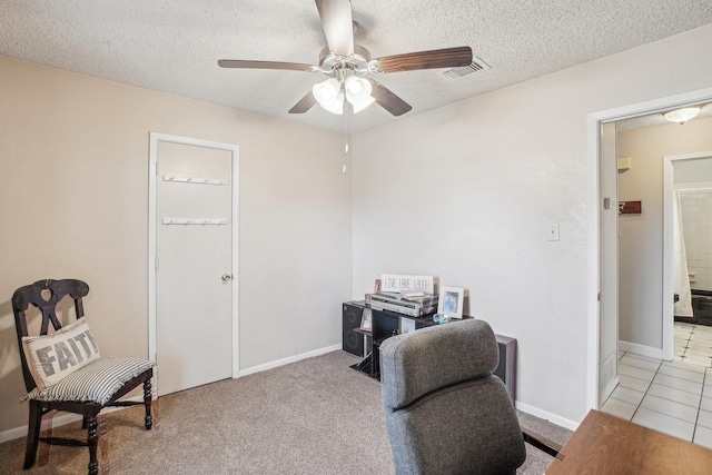 home office with a ceiling fan, baseboards, visible vents, and a textured ceiling