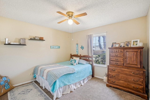 carpeted bedroom featuring a ceiling fan, a textured ceiling, and baseboards