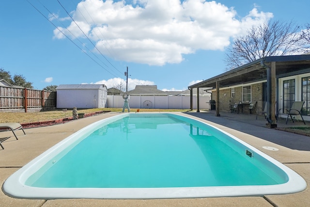 view of pool featuring a fenced in pool, a patio area, an outdoor structure, and a fenced backyard