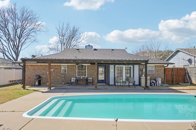 view of swimming pool with a fenced in pool, a patio, grilling area, and fence