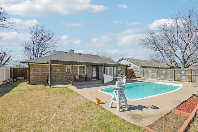 view of swimming pool featuring a fenced backyard, a fenced in pool, a lawn, and a patio