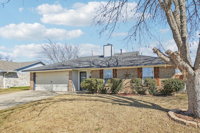 ranch-style house featuring brick siding, a chimney, a front yard, a garage, and driveway