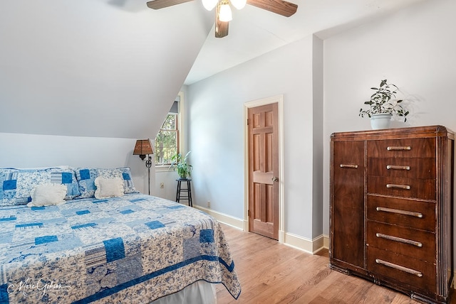 bedroom featuring ceiling fan, lofted ceiling, and light hardwood / wood-style flooring